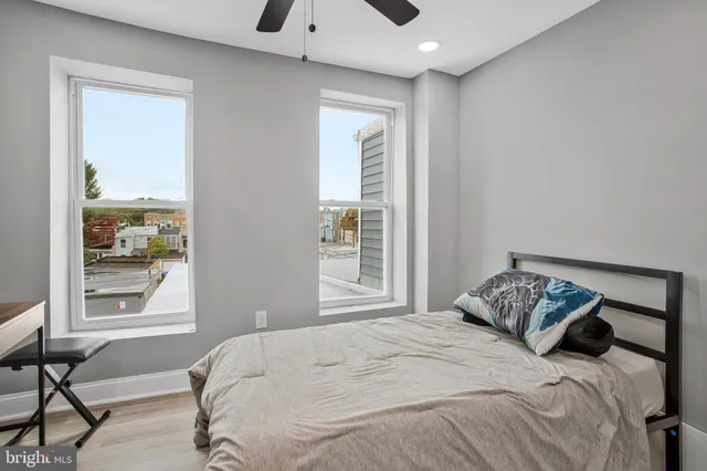 a bedroom with a bed and a window