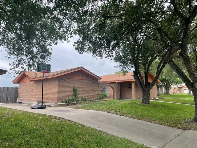 a front view of house with yard and green space