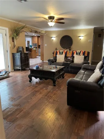 a living room with furniture a rug and a chandelier