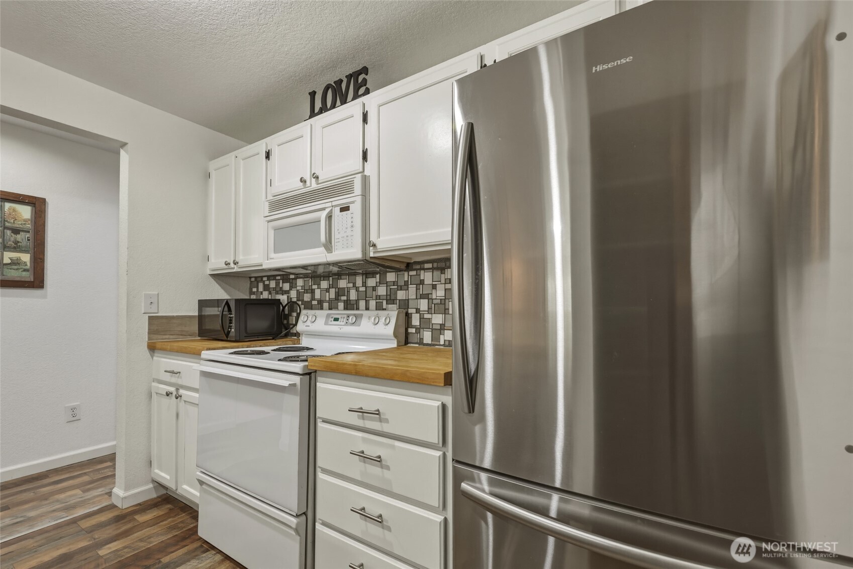 6005 Merlot Lane Southeast Lacey, WA 98513 - Photo 12 of 37 a kitchen with white cabinets and white appliances