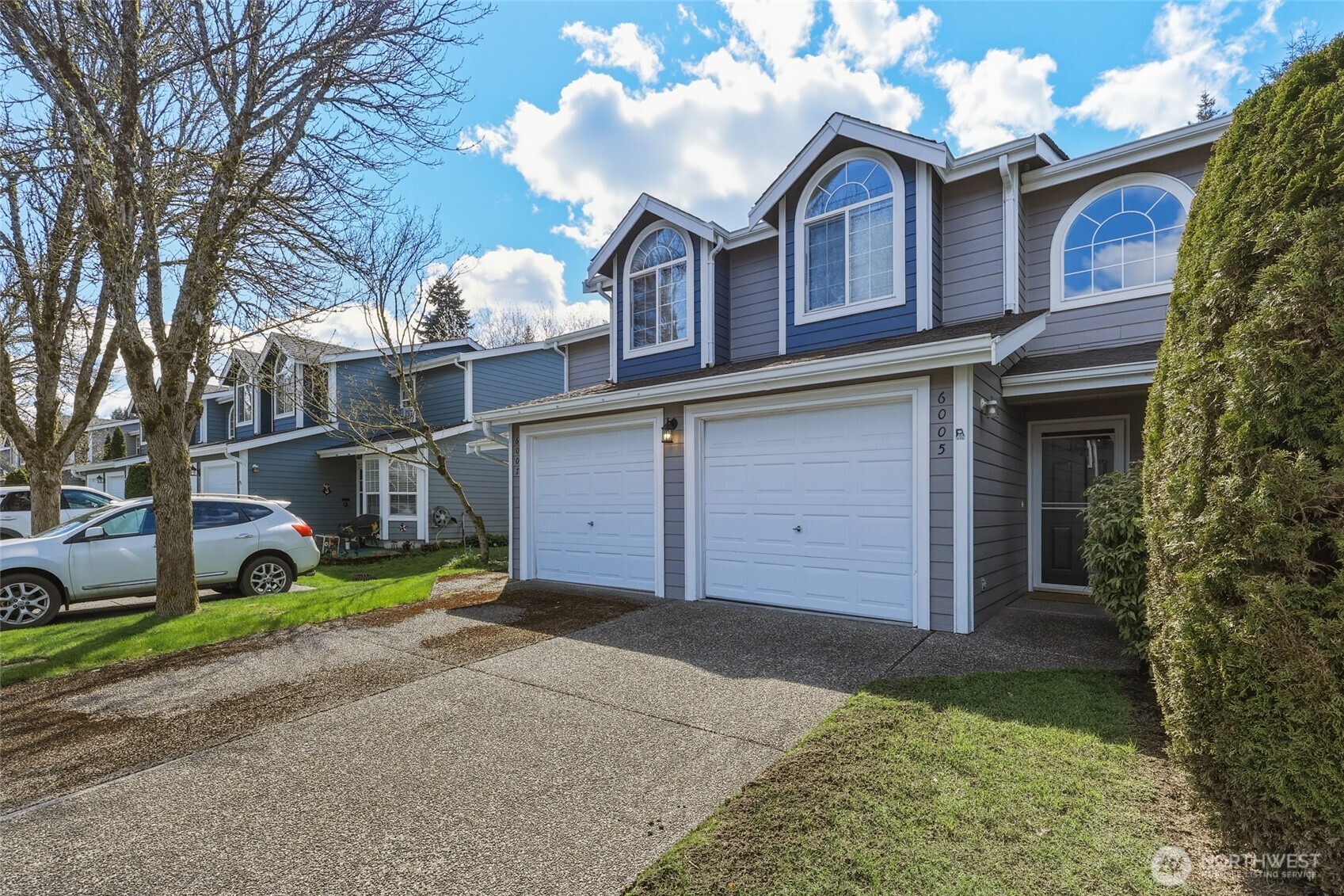 6005 Merlot Lane Southeast Lacey, WA 98513 - Photo 2 of 37 a front view of a house with a yard and garage