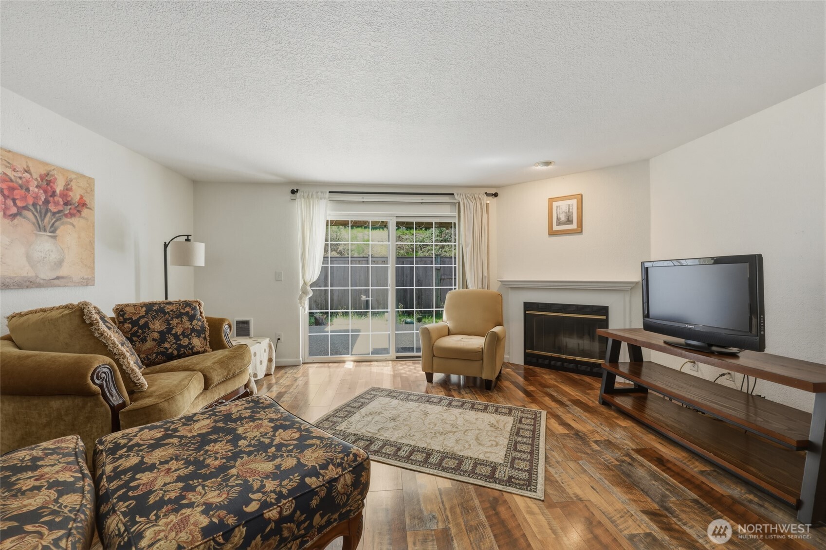 6005 Merlot Lane Southeast Lacey, WA 98513 - Photo 22 of 37 a living room with furniture flat screen tv and a fireplace