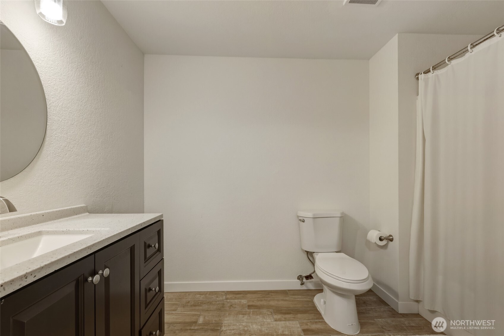 6005 Merlot Lane Southeast Lacey, WA 98513 - Photo 34 of 37 a bathroom with a sink a toilet and a mirror