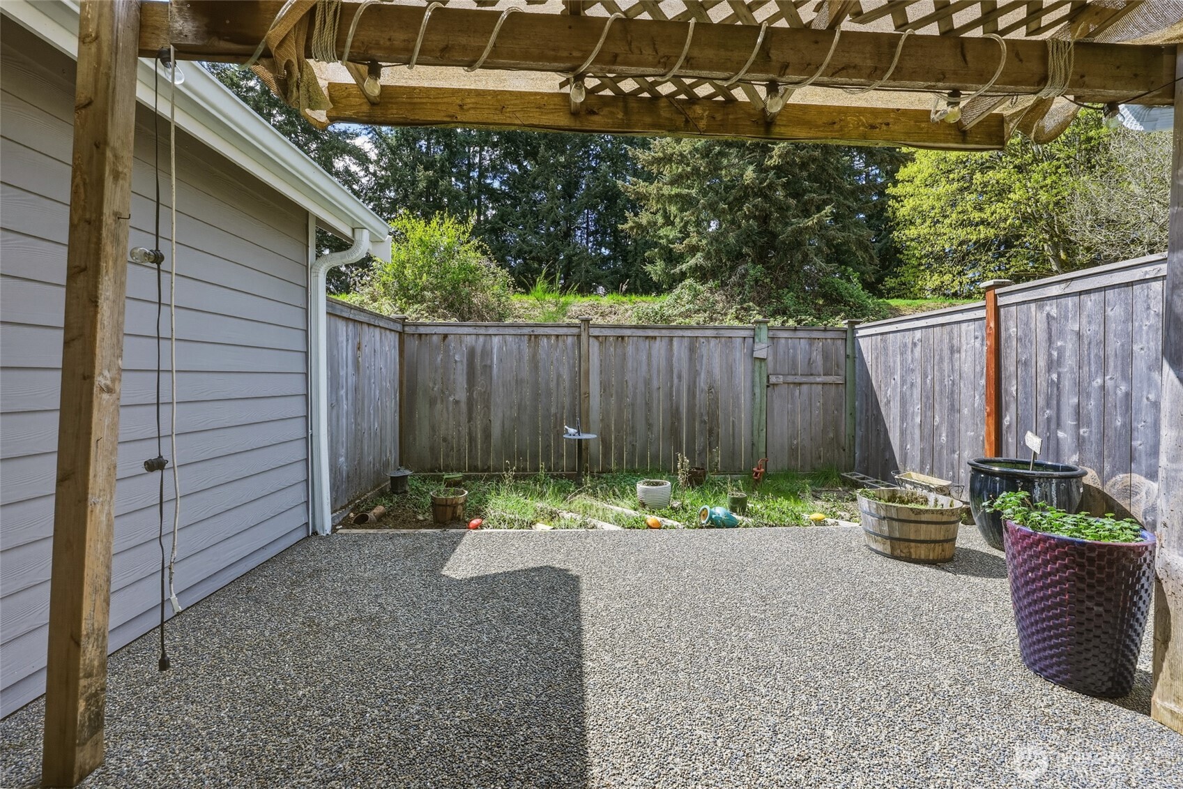 6005 Merlot Lane Southeast Lacey, WA 98513 - Photo 6 of 37 a backyard of a house with a garden and deck