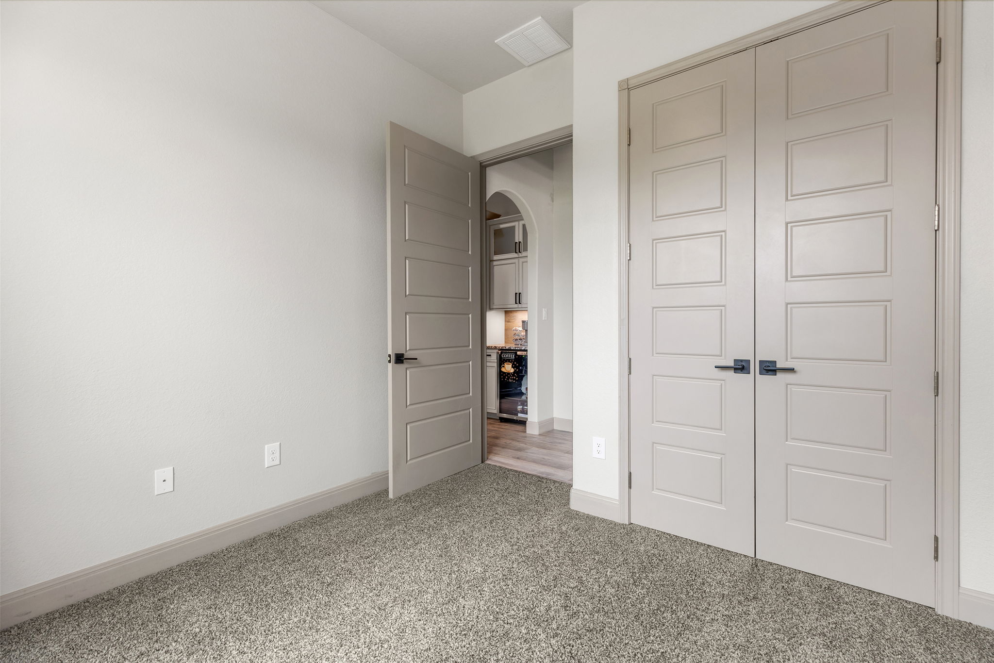 128 Strada Luca Florence, TX 76527 - Photo 28 of 40 Room with plush gray carpet, light gray walls and trim, and modern paneled doors with black hardware.
