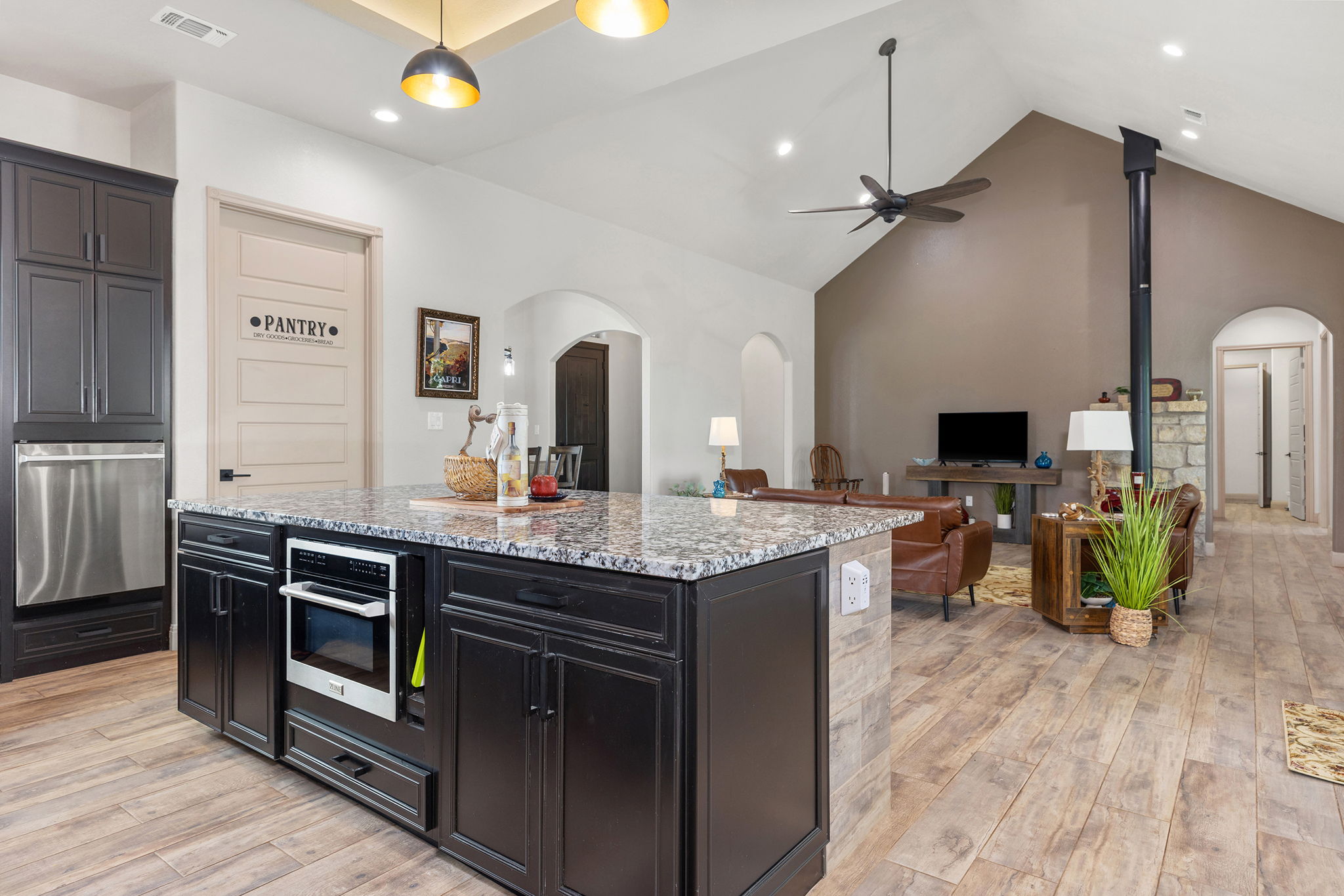 128 Strada Luca Florence, TX 76527 - Photo 9 of 40 Large kitchen island with granite countertop, built-in microwave, and open-concept layout flowing into the living area.