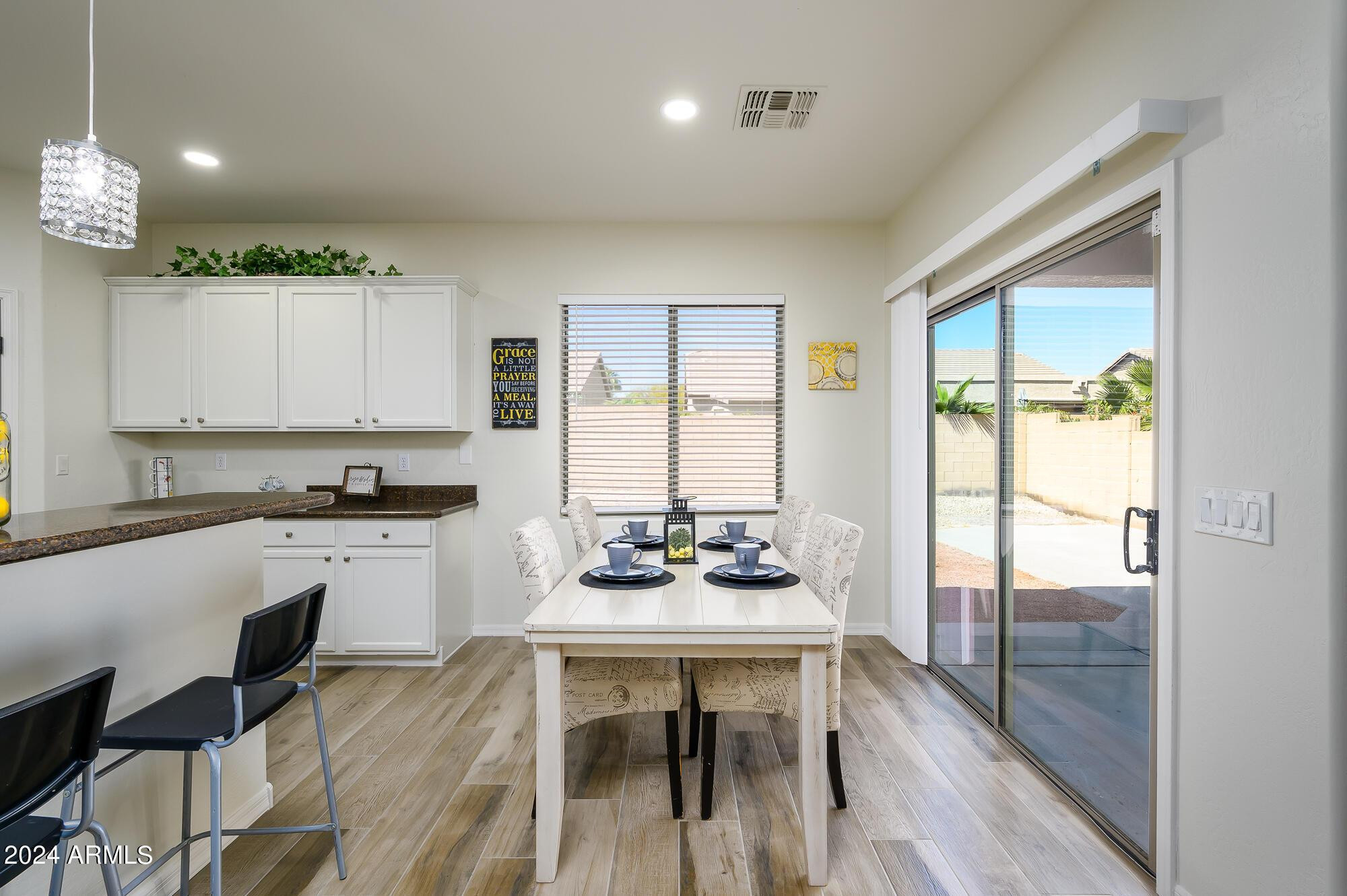17618 West Crocus Drive Surprise, AZ 85388 - Photo 12 of 34 a kitchen with a table chairs stove and cabinets