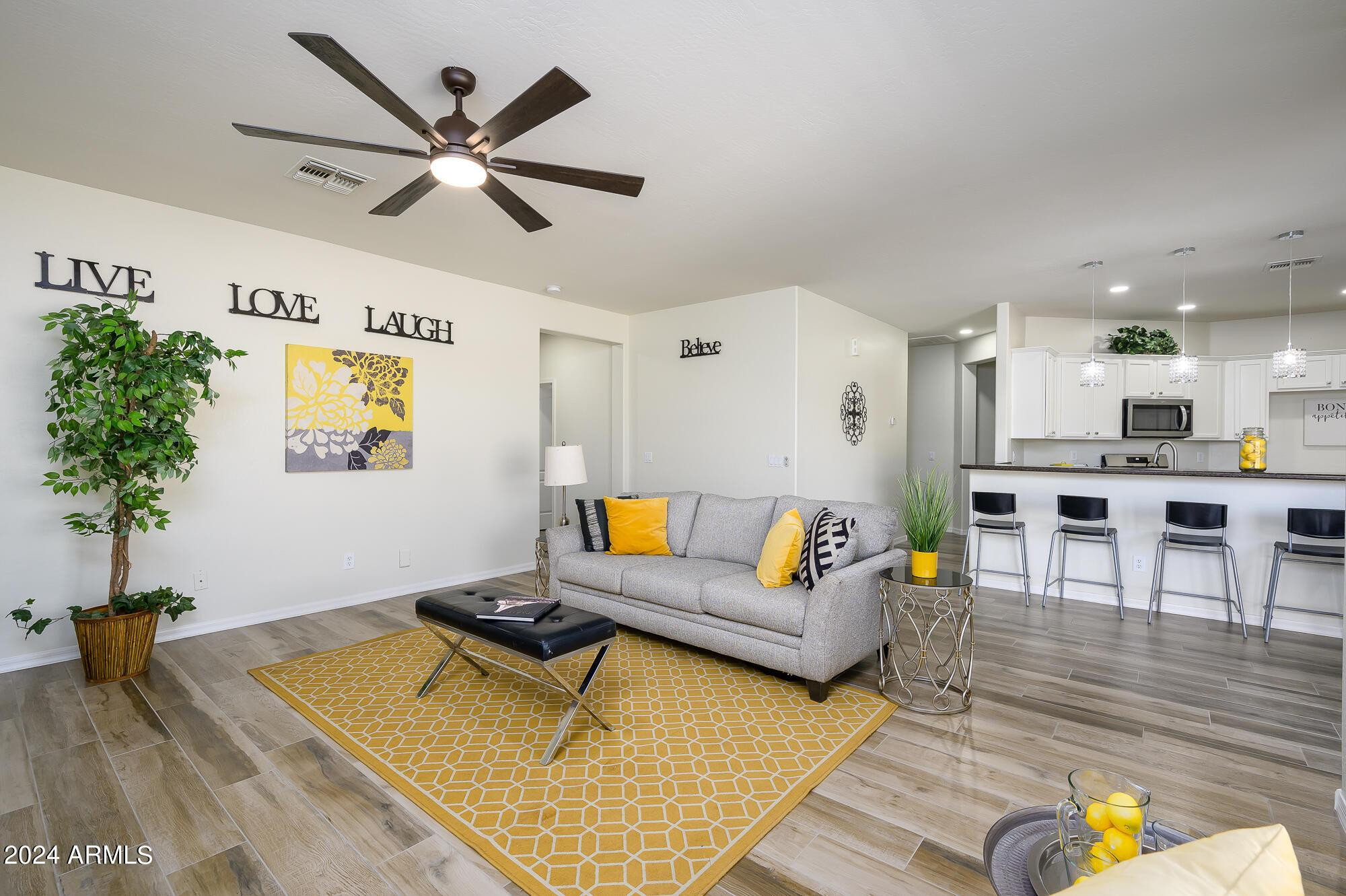 17618 West Crocus Drive Surprise, AZ 85388 - Photo 15 of 34 a living room with furniture and wooden floor