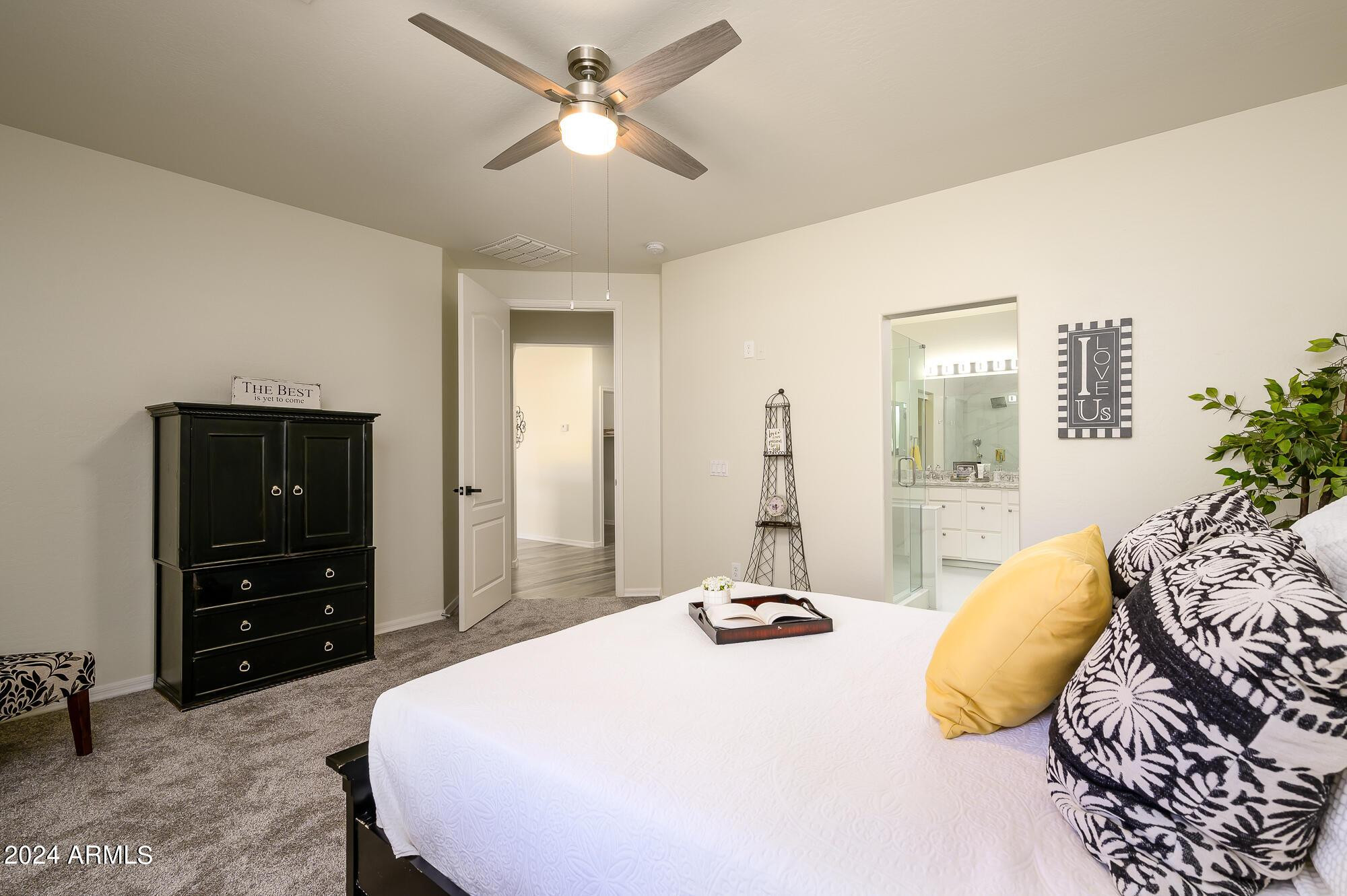 17618 West Crocus Drive Surprise, AZ 85388 - Photo 17 of 34 a bedroom with a bed and ceiling fan