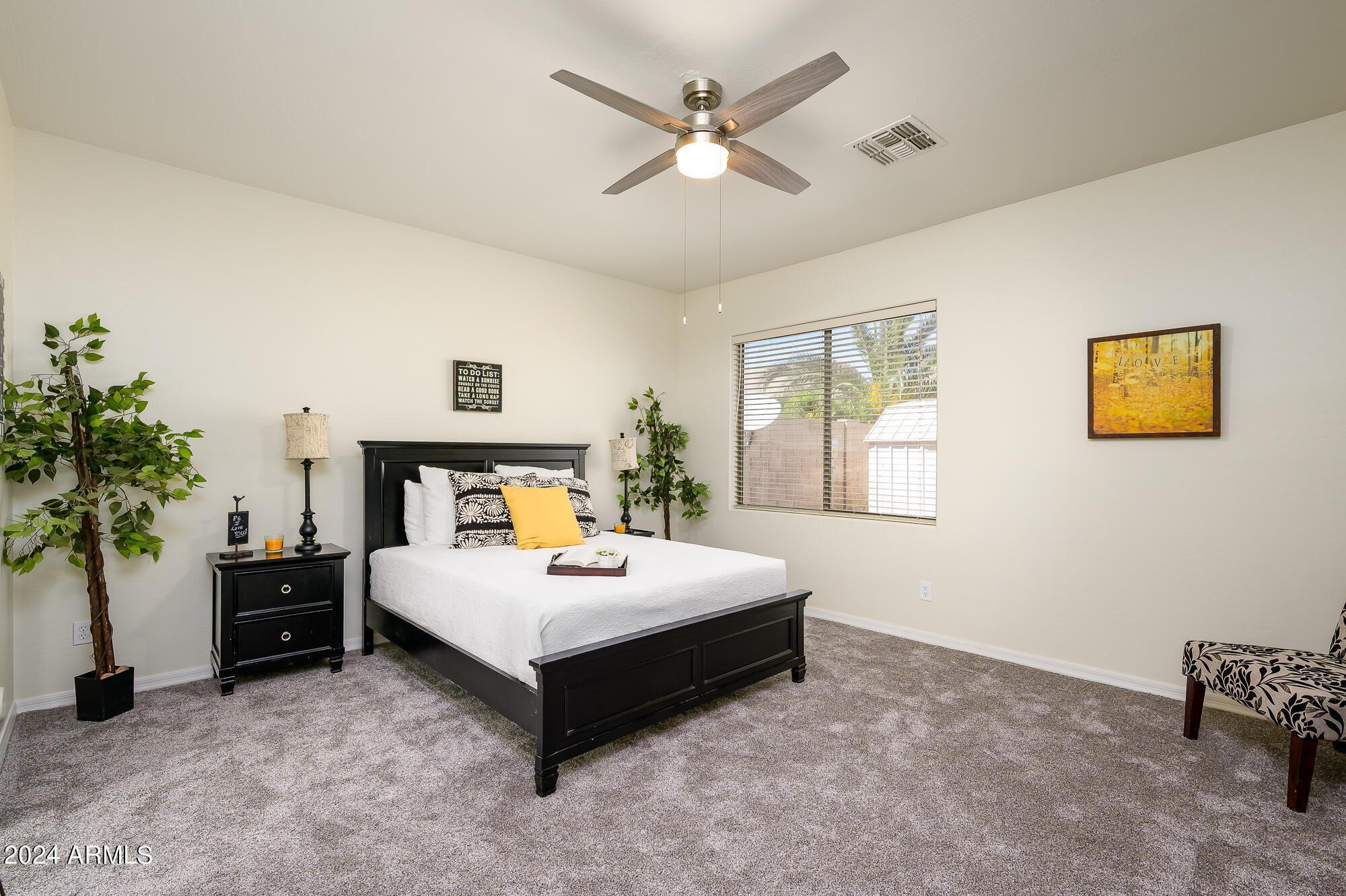 17618 West Crocus Drive Surprise, AZ 85388 - Photo 18 of 34 a spacious bedroom with a bed and a table
