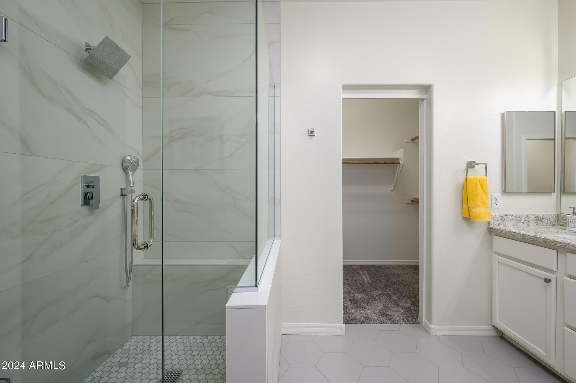 17618 West Crocus Drive Surprise, AZ 85388 - Photo 19 of 34 a bathroom with a granite countertop sink a mirror and shower