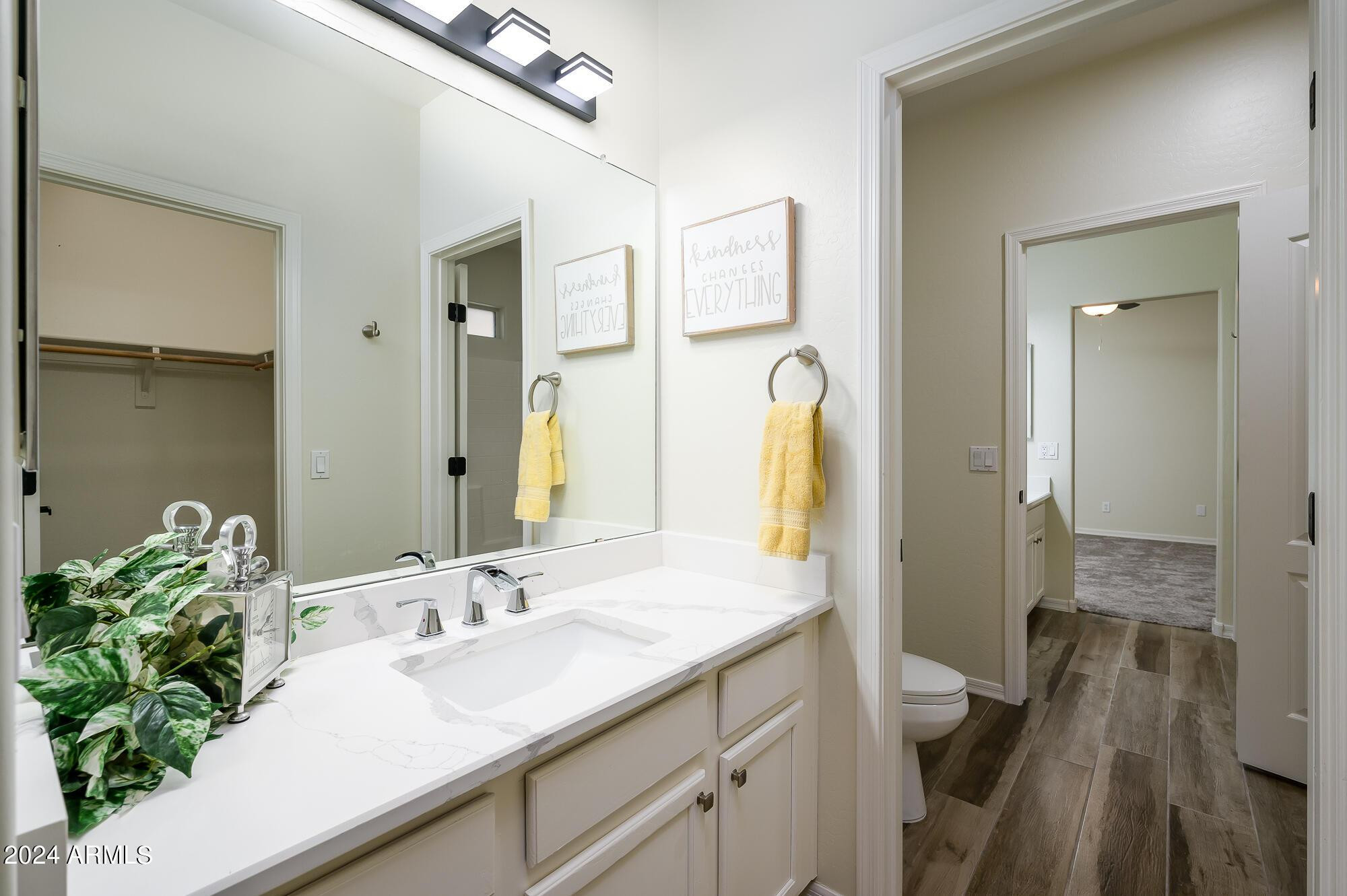 17618 West Crocus Drive Surprise, AZ 85388 - Photo 29 of 34 a bathroom with a granite countertop sink and a mirror
