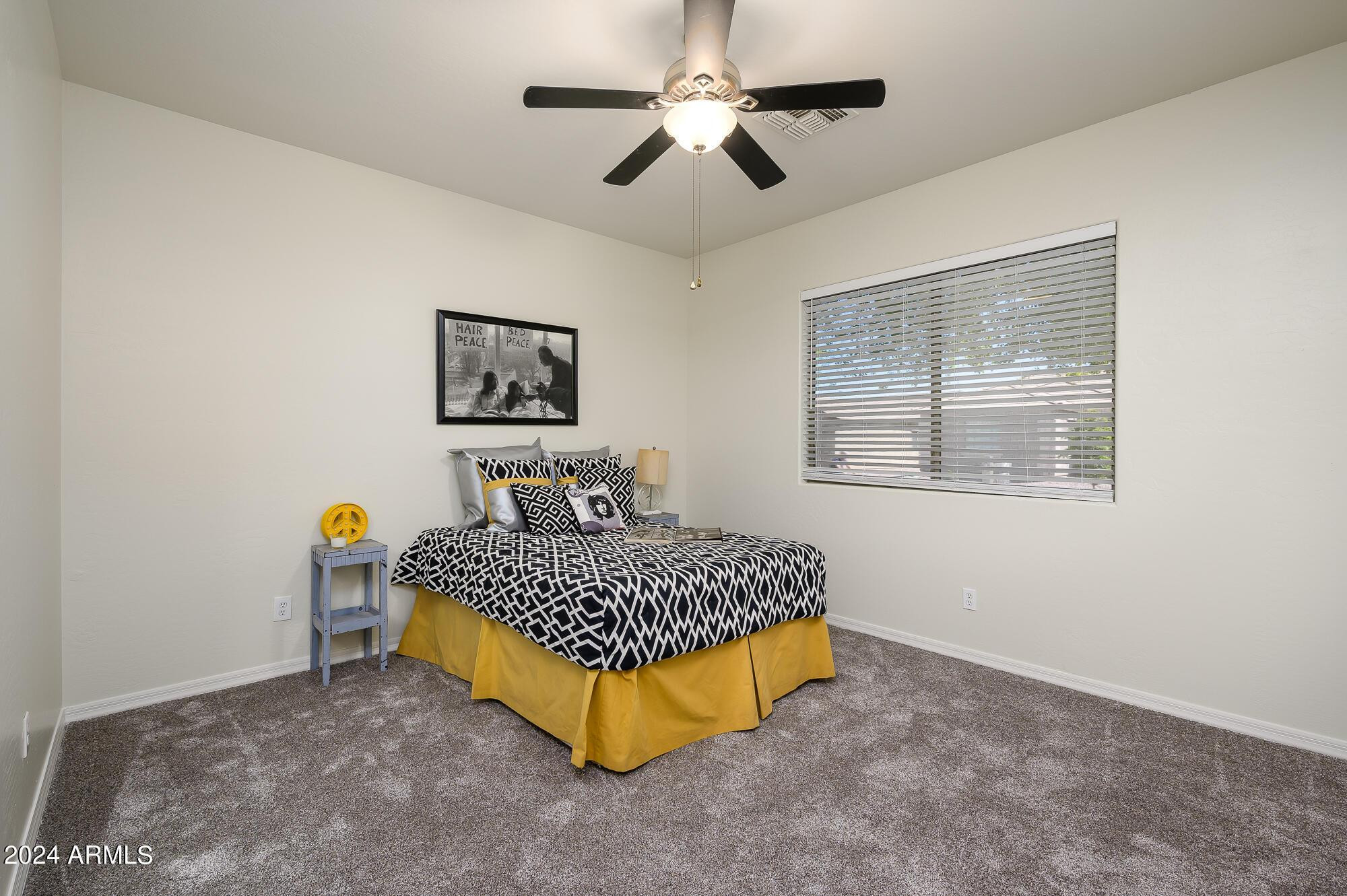 17618 West Crocus Drive Surprise, AZ 85388 - Photo 31 of 34 a bedroom with a bed a lamp on desk and a window