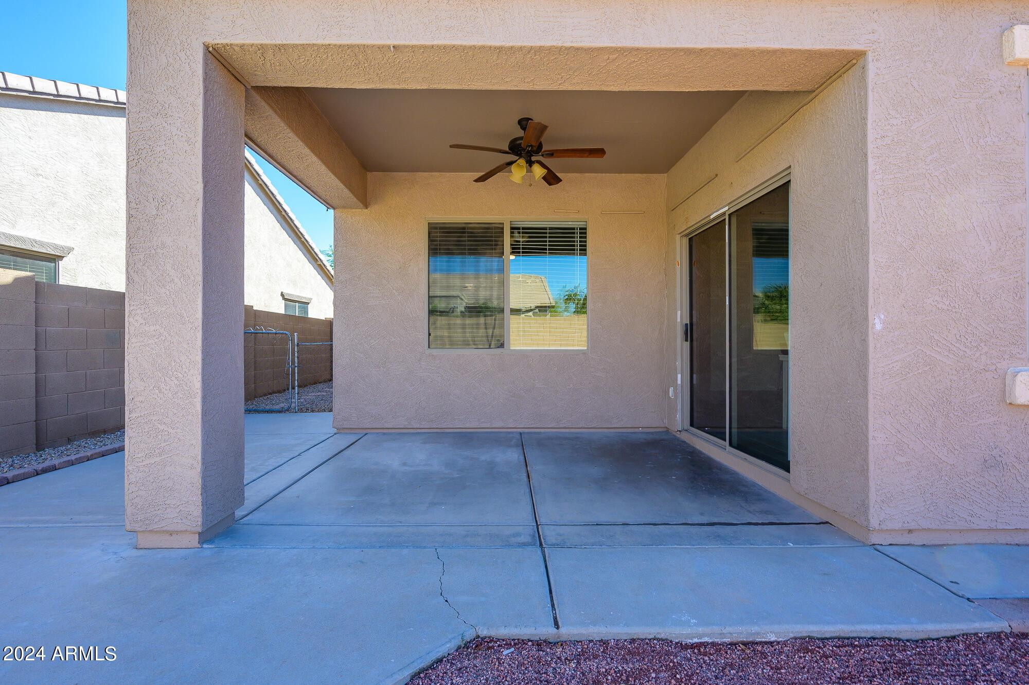 17618 West Crocus Drive Surprise, AZ 85388 - Photo 32 of 34 an empty room with windows and ceiling fan