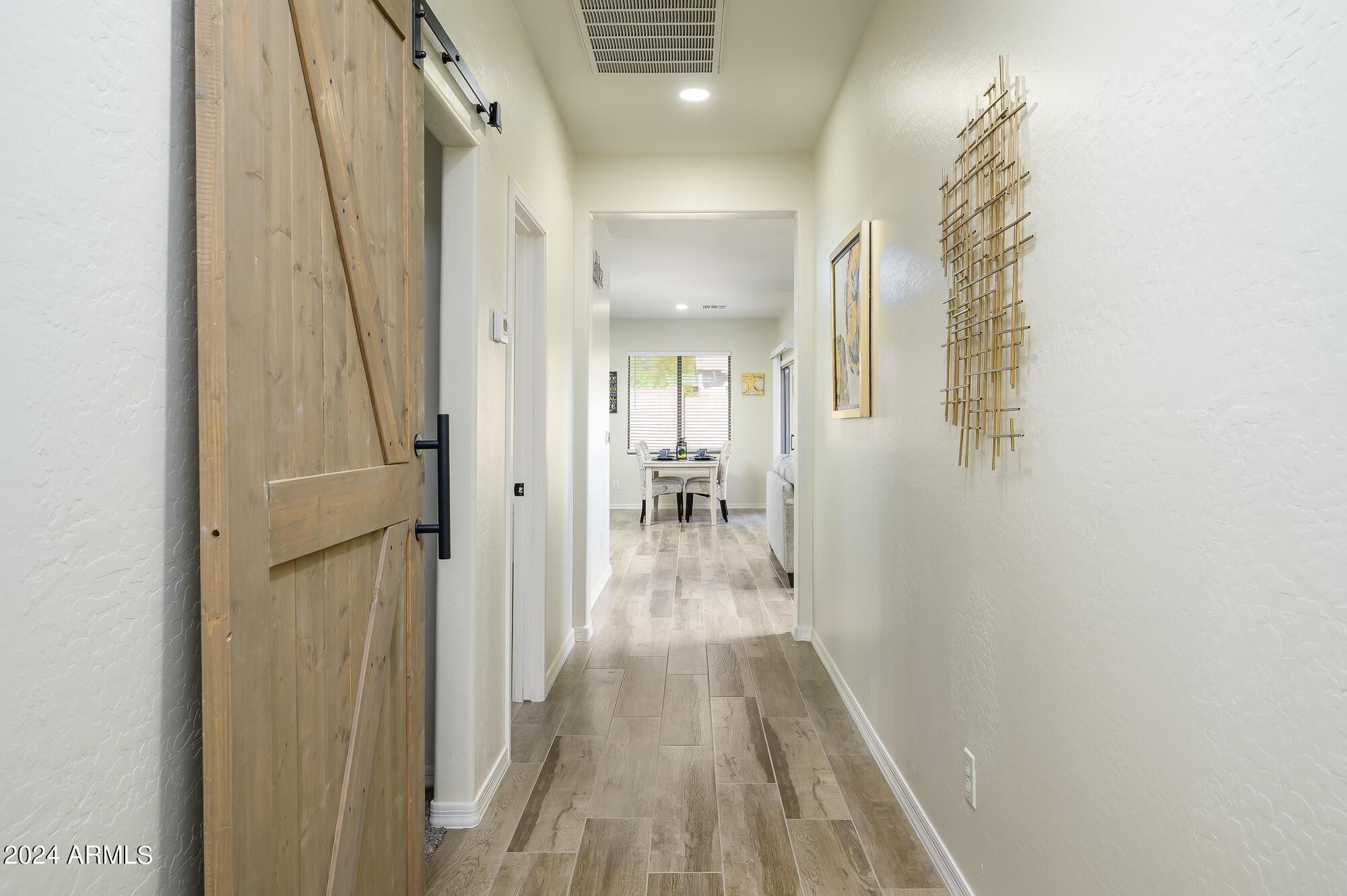 17618 West Crocus Drive Surprise, AZ 85388 - Photo 7 of 34 a view of a hallway with wooden floor and staircase