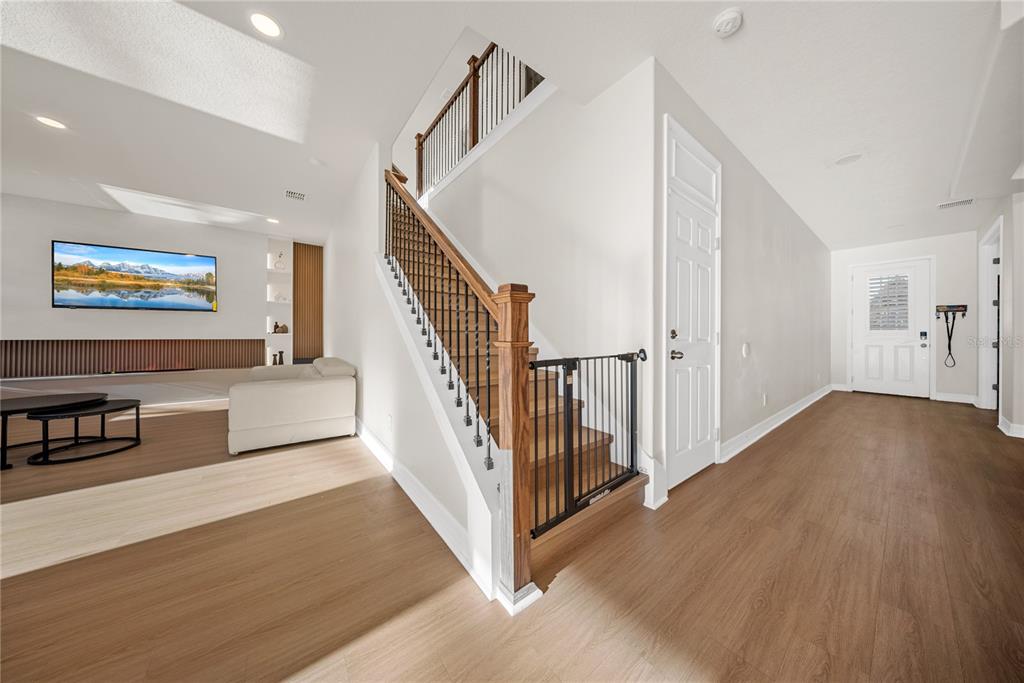 8252 Randal Park Boulevard Orlando, FL 32832 - Photo 17 of 63 a view of a hallway with wooden floor and stairs