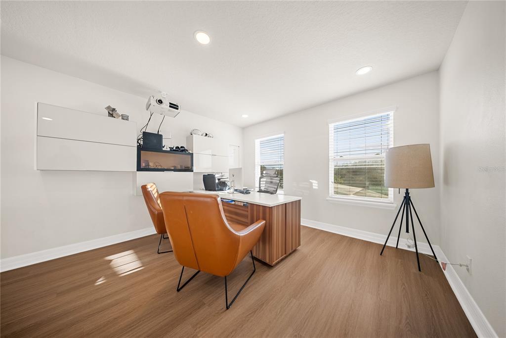 8252 Randal Park Boulevard Orlando, FL 32832 - Photo 23 of 63 a living room with furniture and a wooden floor