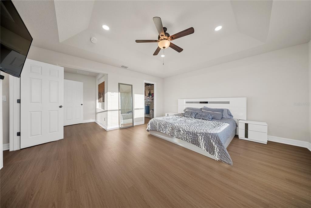 8252 Randal Park Boulevard Orlando, FL 32832 - Photo 27 of 63 a room with a bed and ceiling fan