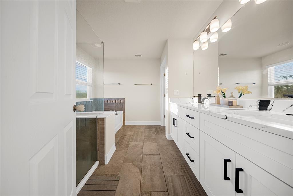 8252 Randal Park Boulevard Orlando, FL 32832 - Photo 28 of 63 a bathroom with a double vanity sink and a mirror