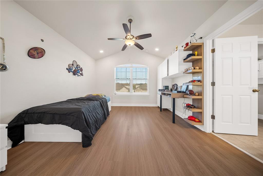 8252 Randal Park Boulevard Orlando, FL 32832 - Photo 33 of 63 a bedroom with a bed and a book shelf