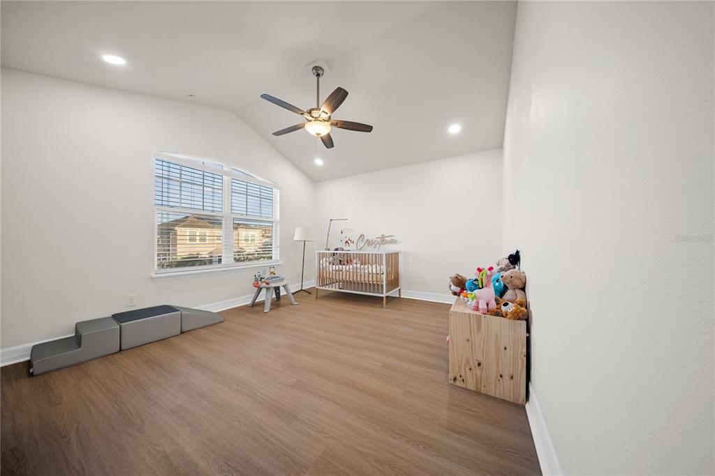 8252 Randal Park Boulevard Orlando, FL 32832 - Photo 38 of 63 a view of a room with wooden floor and ceiling fan