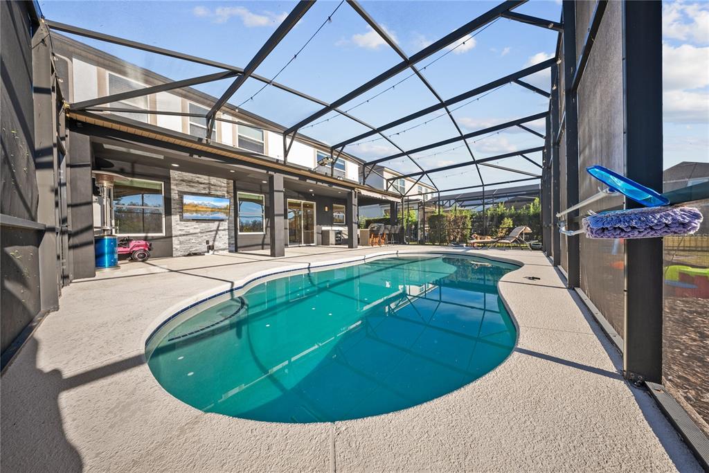 8252 Randal Park Boulevard Orlando, FL 32832 - Photo 48 of 63 a view of a swimming pool with a patio