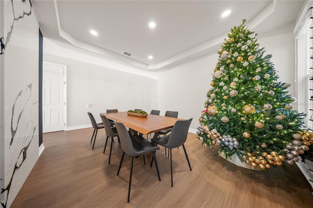 8252 Randal Park Boulevard Orlando, FL 32832 - Photo 8 of 63 a view of a dining room with furniture and wooden floor