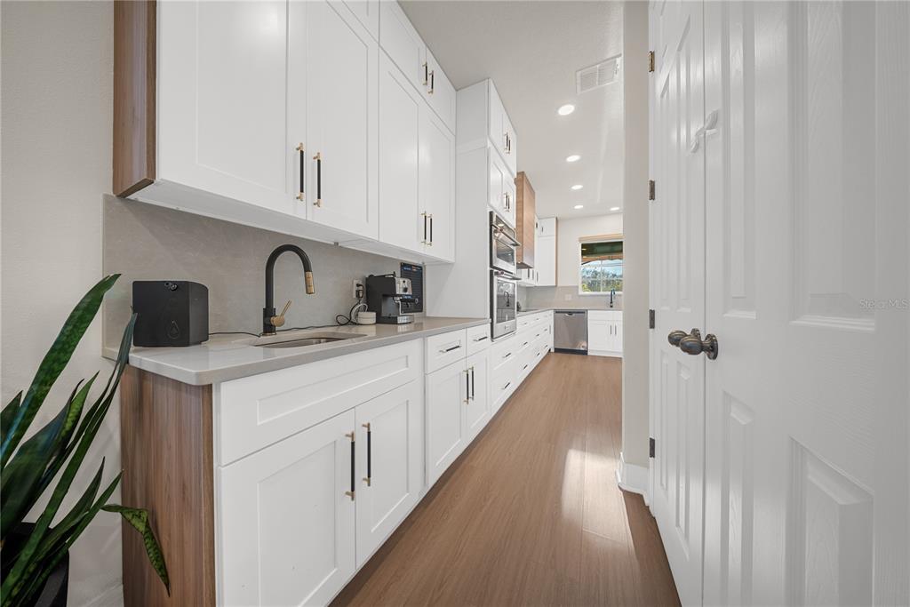 8252 Randal Park Boulevard Orlando, FL 32832 - Photo 9 of 63 a kitchen with white cabinets and sink