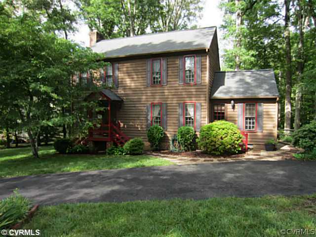 a brick house with potted plants in front of it