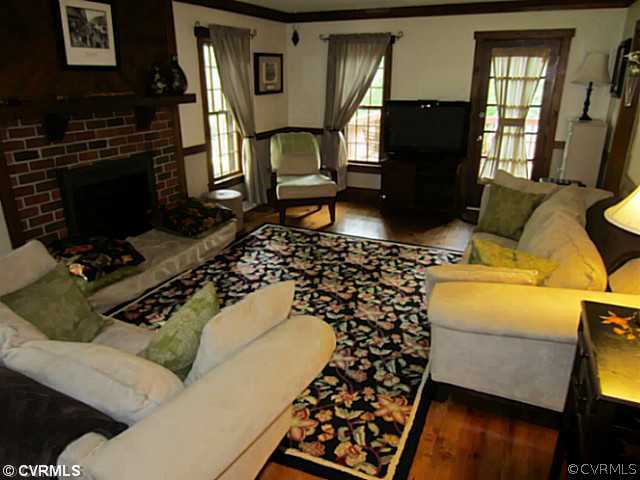 7950 Millvale Road Chesterfield, VA 23832 - Photo 7 of 18 a living room with a couch and a flat screen tv