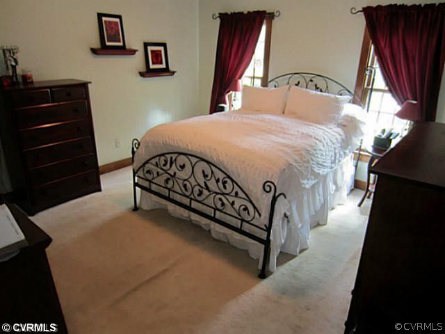 7950 Millvale Road Chesterfield, VA 23832 - Photo 10 of 18 a bedroom with a bed and a mirror on dresser