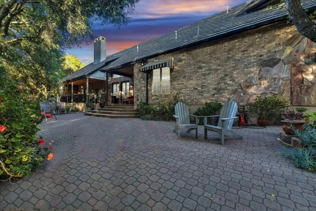 a backyard of a house with yard and outdoor seating