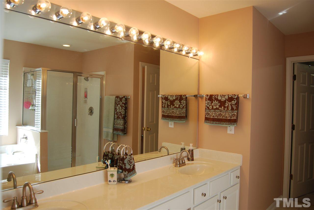 1502 Nealstone Way Raleigh, NC 27614 - Photo 14 of 25 a bathroom with a double vanity sink mirror and shower