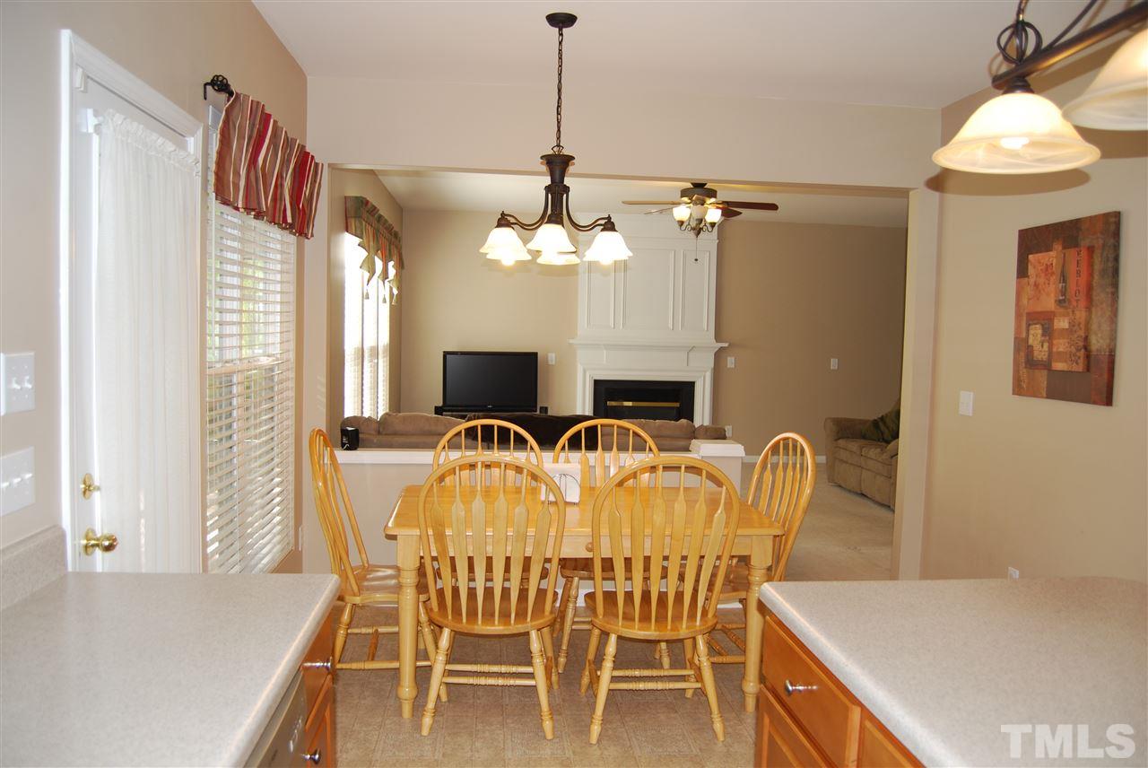 1502 Nealstone Way Raleigh, NC 27614 - Photo 8 of 25 a view of a dining room with furniture and chandelier