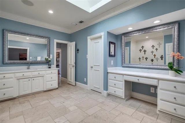 a bedroom with bed and paintings on wall