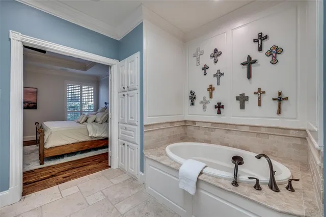 a bathroom with a tub a sink and a large mirror