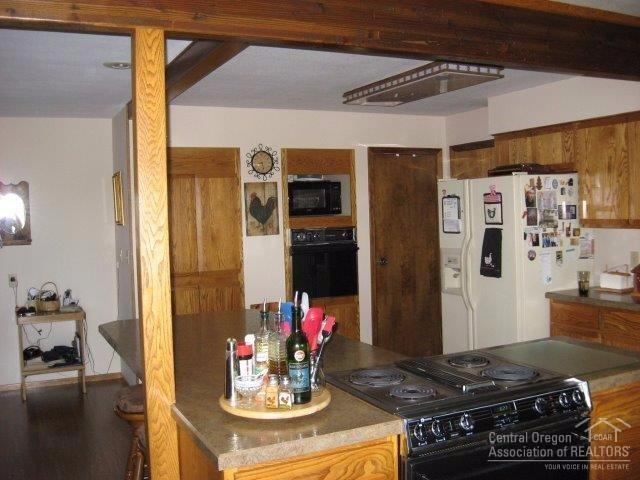 27103 Ridge Road John Day, OR 97845 - Photo 7 of 25 a kitchen with stainless steel appliances granite countertop a stove and refrigerator