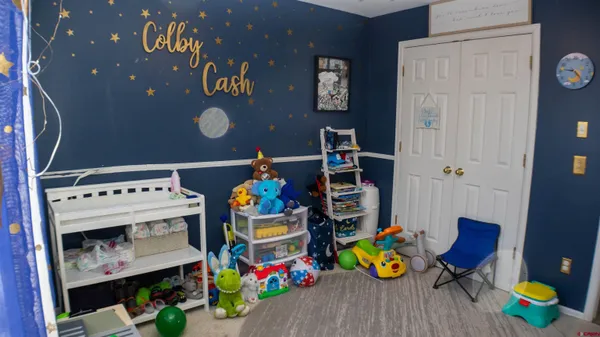 a view of play room with chairs and toys