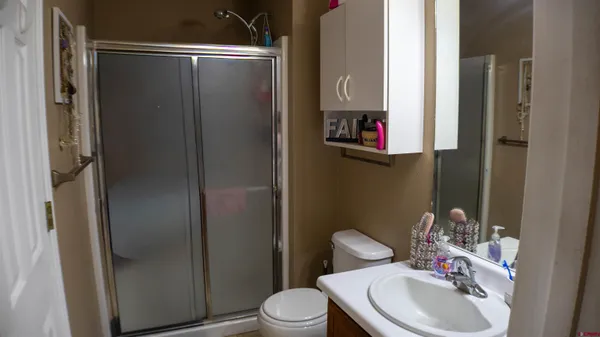 a bathroom with a sink toilet and a mirror