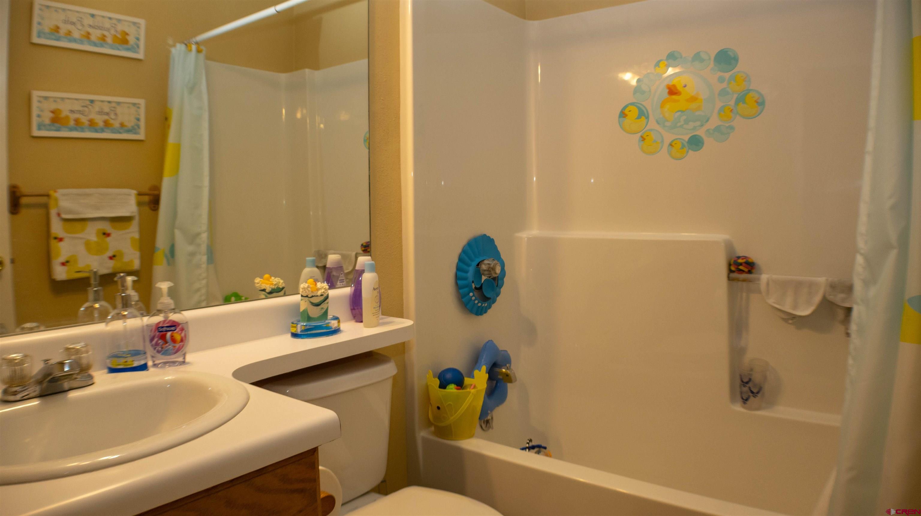 304 West 3rd Street Delta, CO 81416 - Photo 16 of 28 a bathroom with a sink mirror vanity and toilet