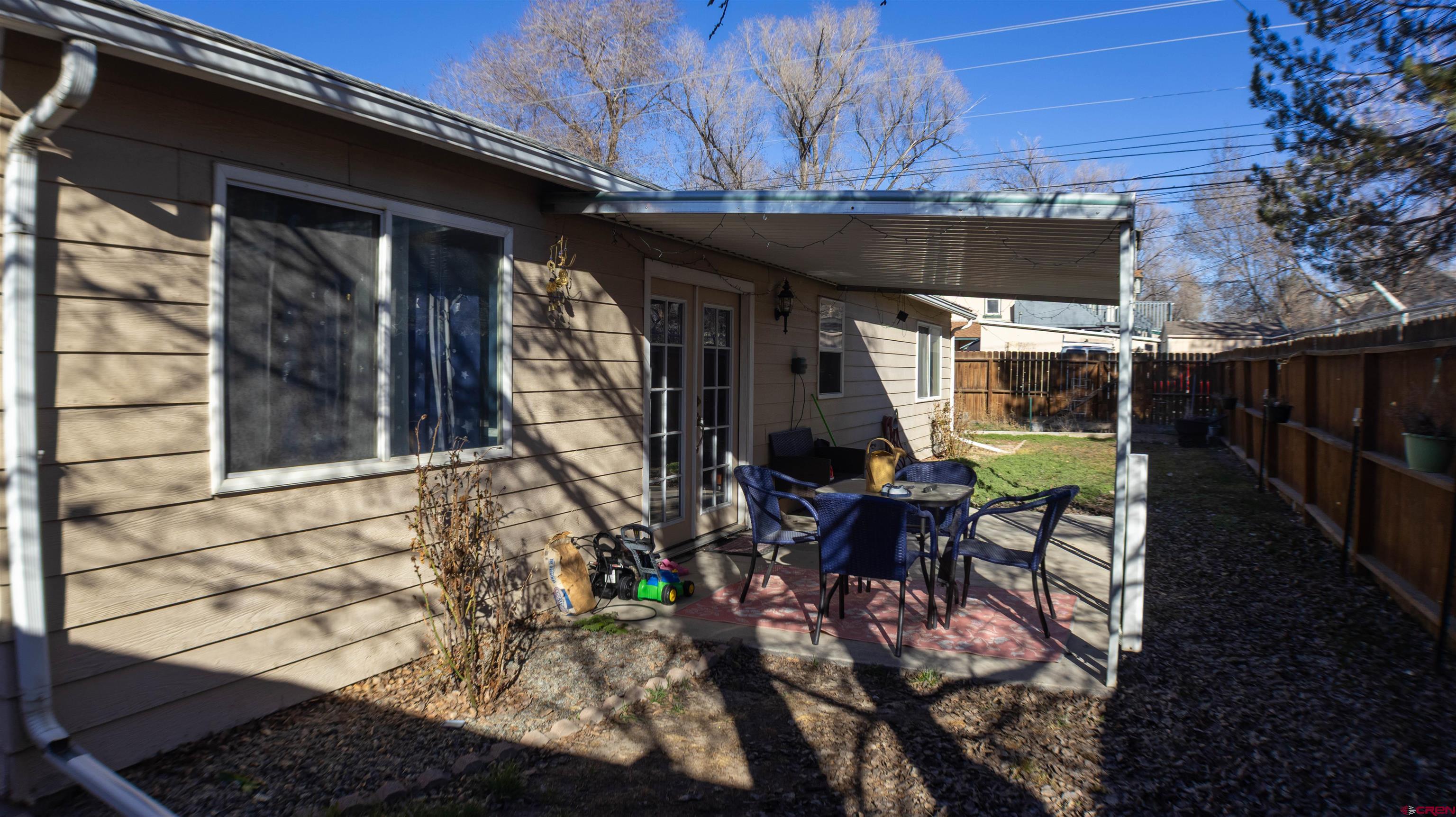 304 West 3rd Street Delta, CO 81416 - Photo 19 of 28 a front view of a house with outdoor seating and a patio