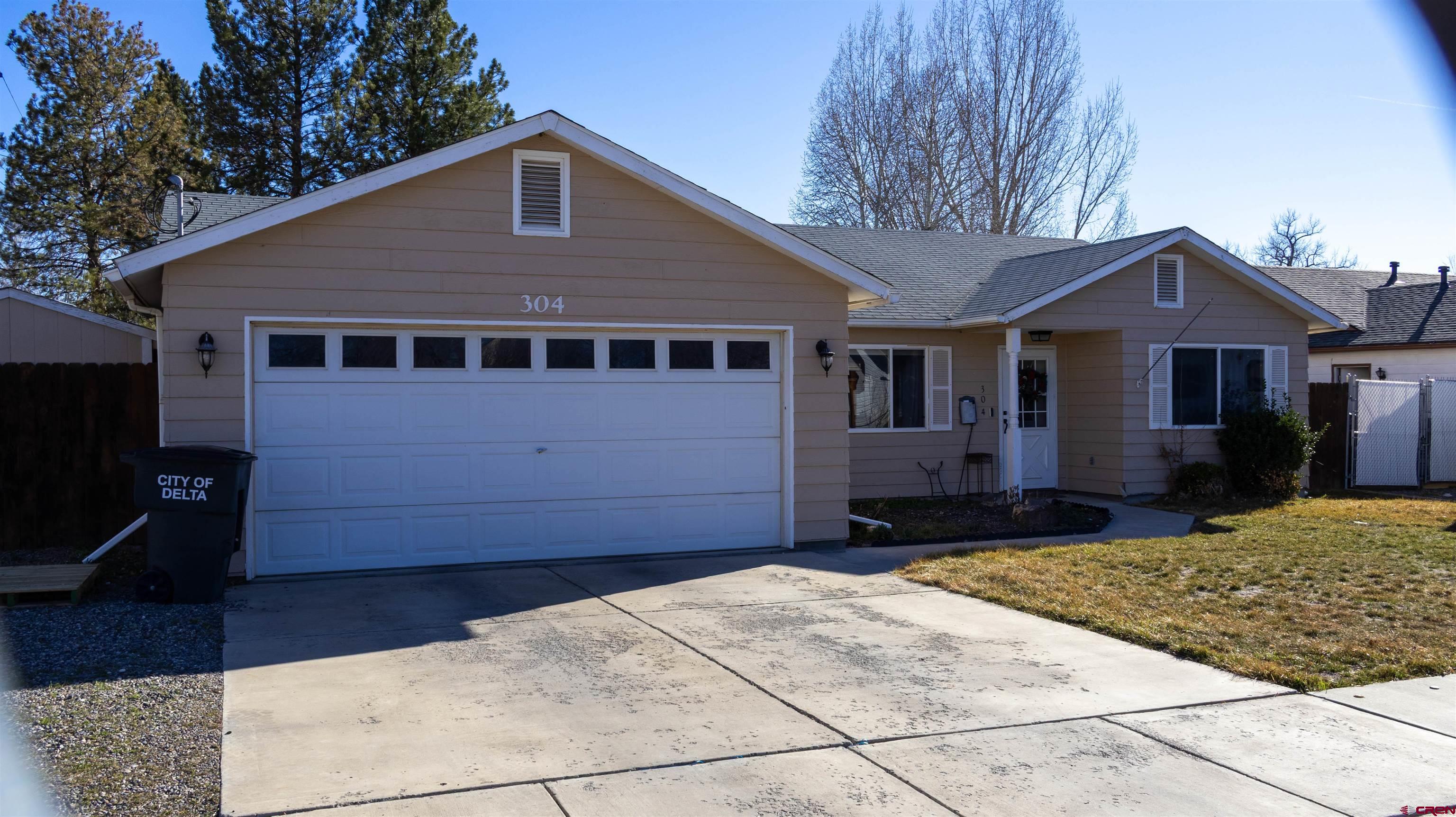 304 West 3rd Street Delta, CO 81416 - Photo 2 of 28 a front view of a house with a yard