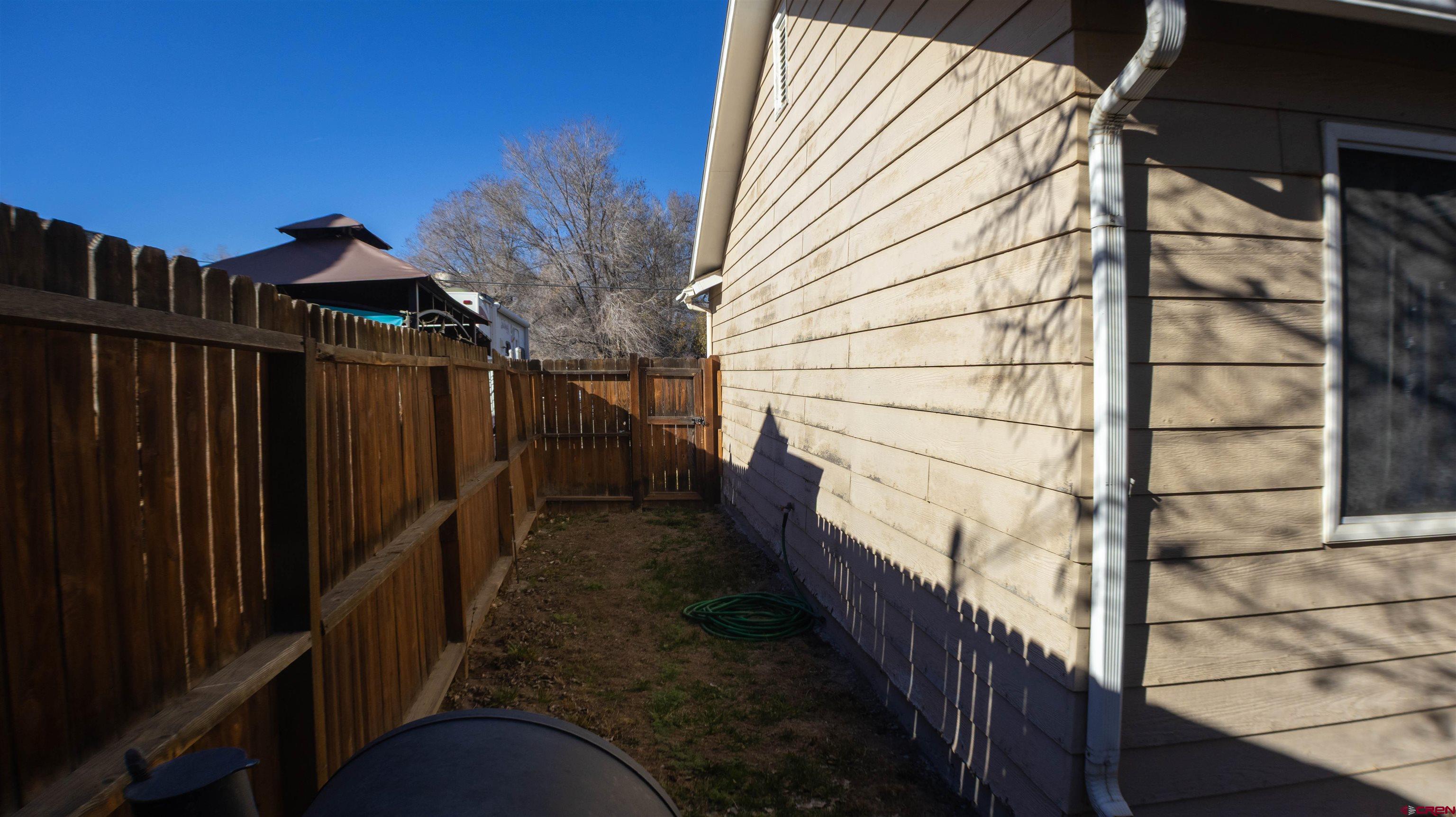 304 West 3rd Street Delta, CO 81416 - Photo 23 of 28 a house view with wooden fencing