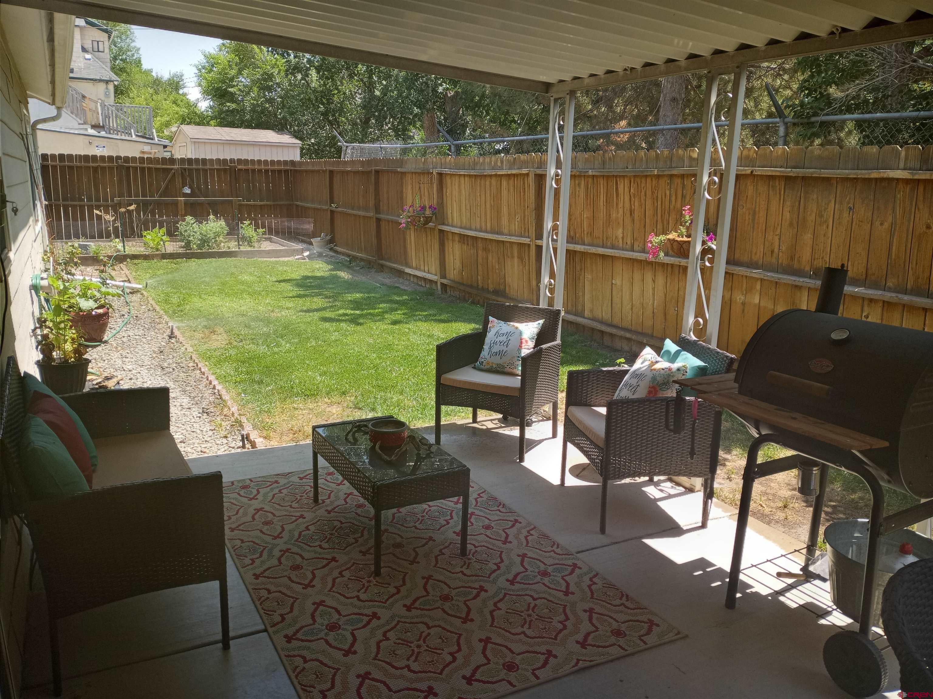 304 West 3rd Street Delta, CO 81416 - Photo 26 of 28 a backyard of a house with table and chairs