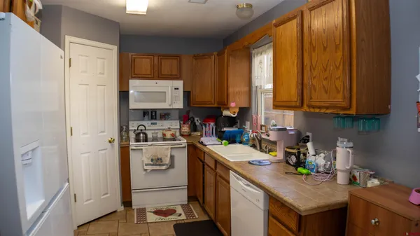 a kitchen with a sink a stove and cabinets