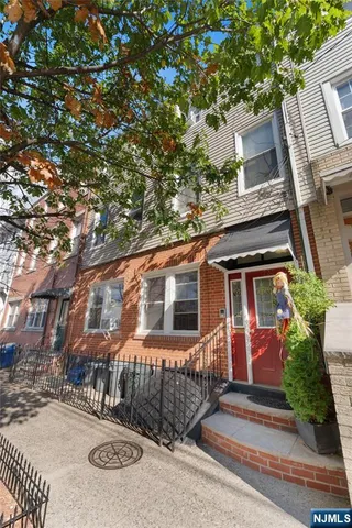 front view of a house with a tree
