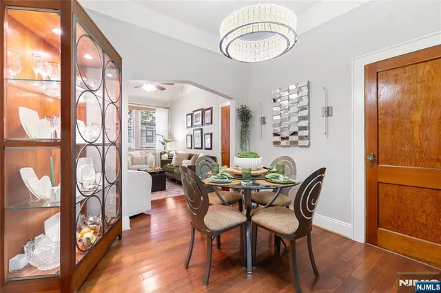 a view of a dining room with furniture and a chandelier