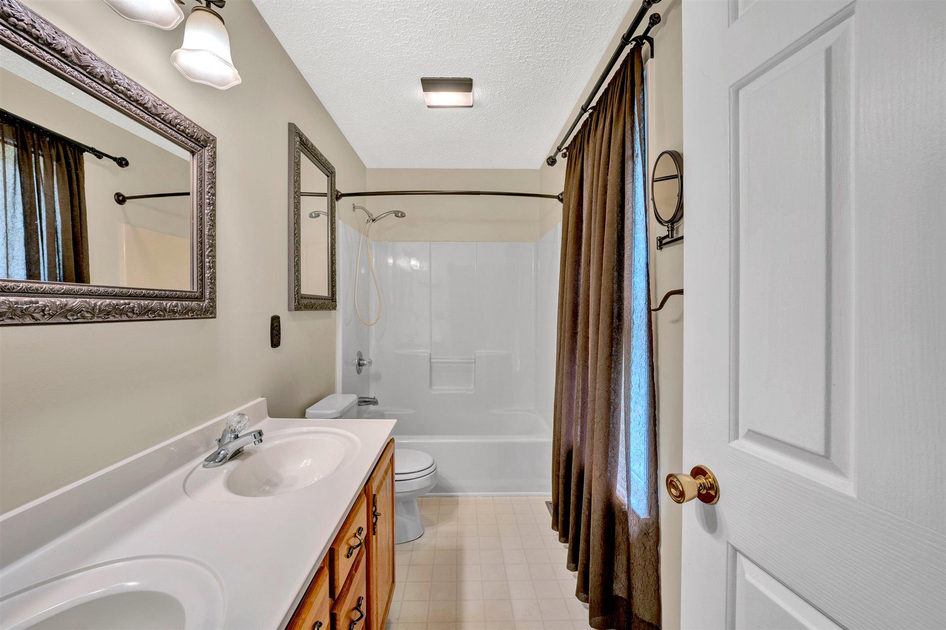 445 Middle Ridge Drive Callaway, VA 24067 - Photo 13 of 25 a bathroom with a tub sink and mirror