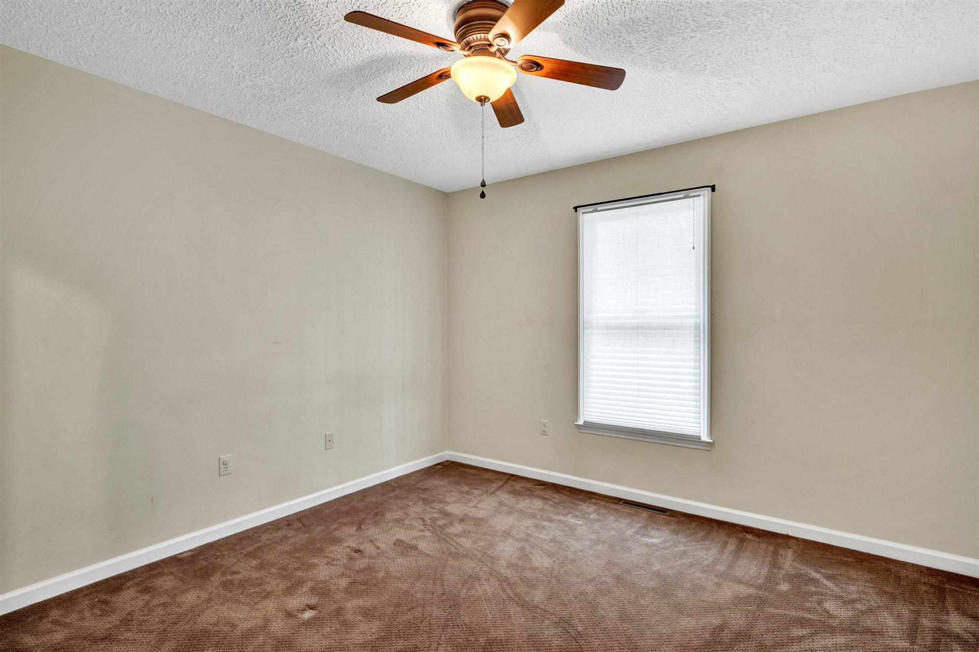 445 Middle Ridge Drive Callaway, VA 24067 - Photo 14 of 25 an empty room with a window and a fan