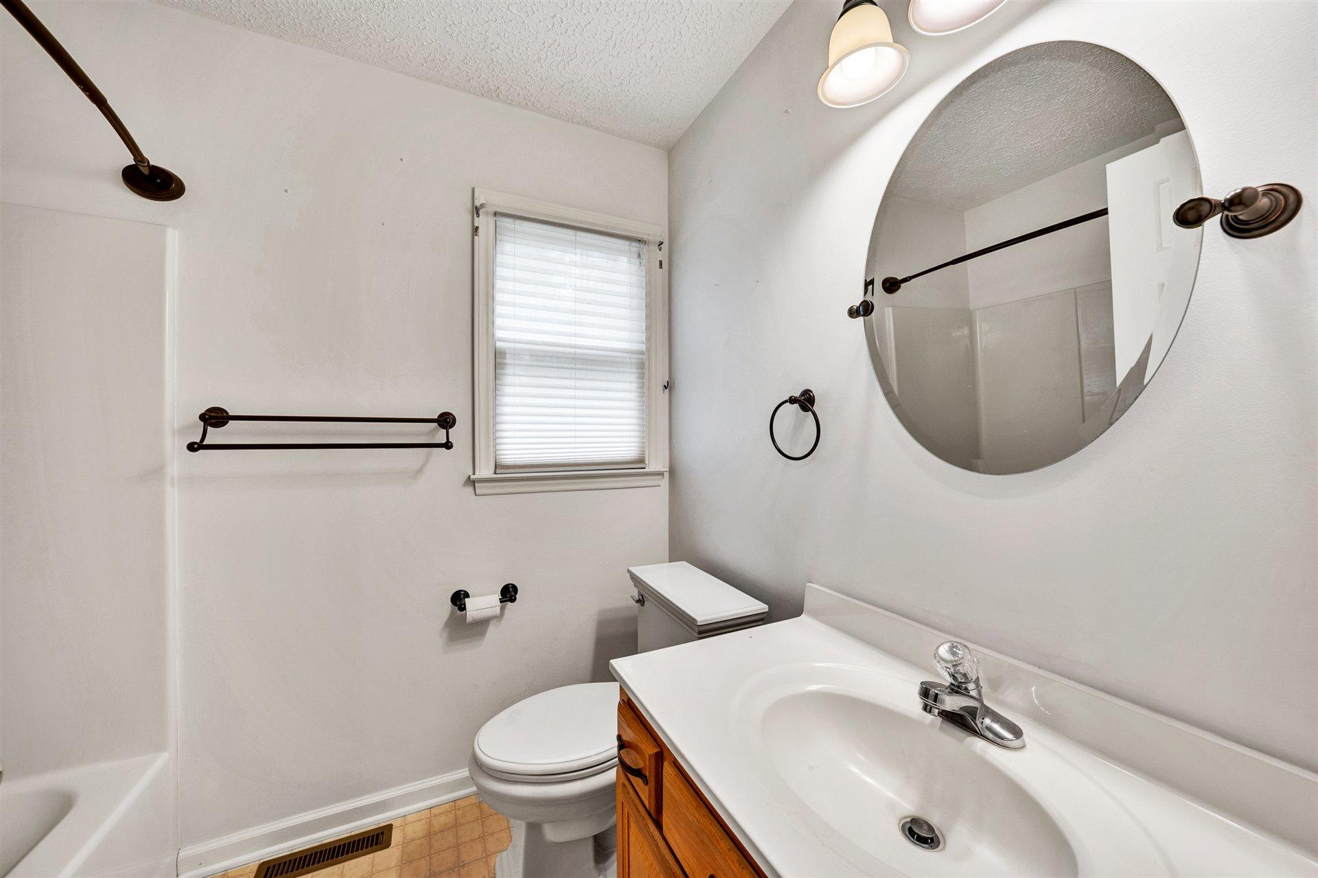 445 Middle Ridge Drive Callaway, VA 24067 - Photo 16 of 25 a bathroom with a sink toilet and mirror